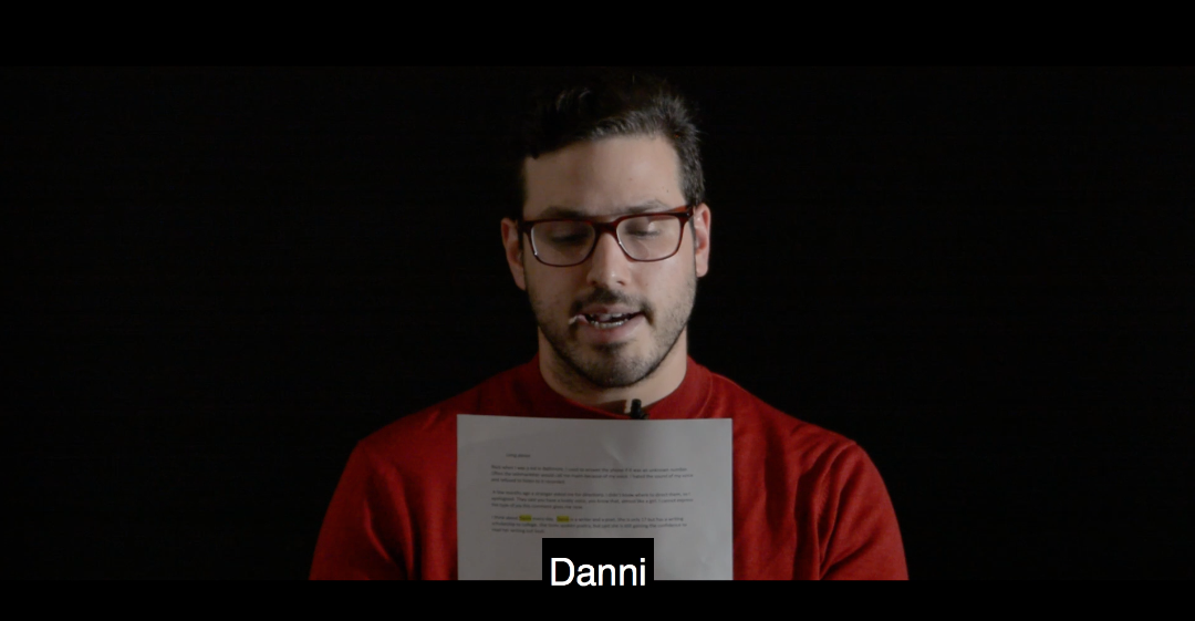 man in red glasses reads from script