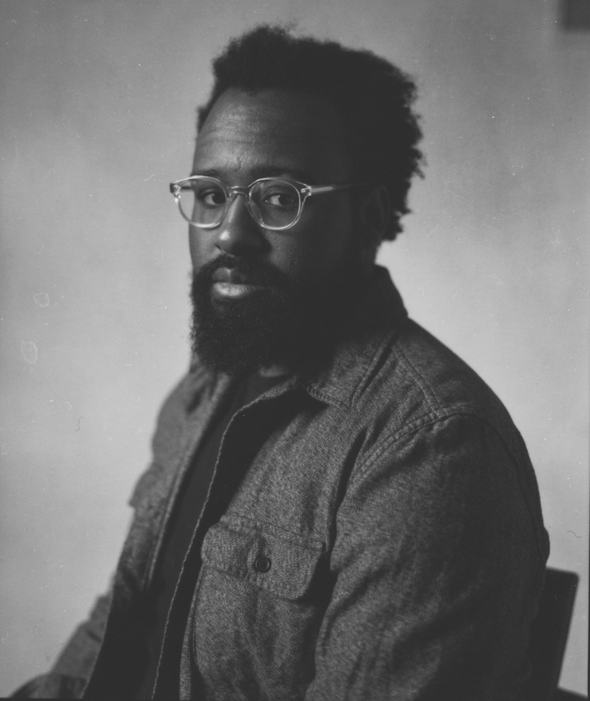 Zora Murff black and white headshot with glasses