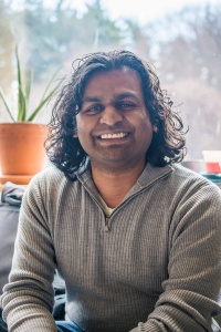 Headshot of a man in front of a window