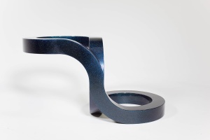 A steel beam sculpture in a curved form against a white background. The sculpture is powder-costed with a deep blue and iridescent glitter finish.
