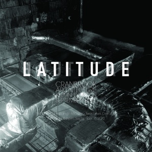 White, bold, all capital text across the middle of the square image reads "LATITUDE". In the background is a black and white image of an artwork made of metallic ducting.