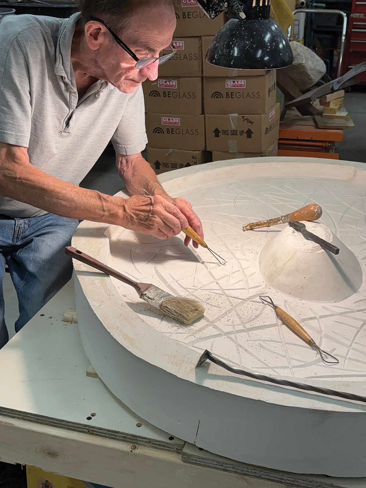 Man carving plaster mold